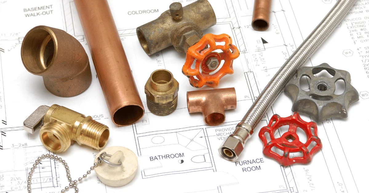 plumbing components on top of a bathroom blueprint