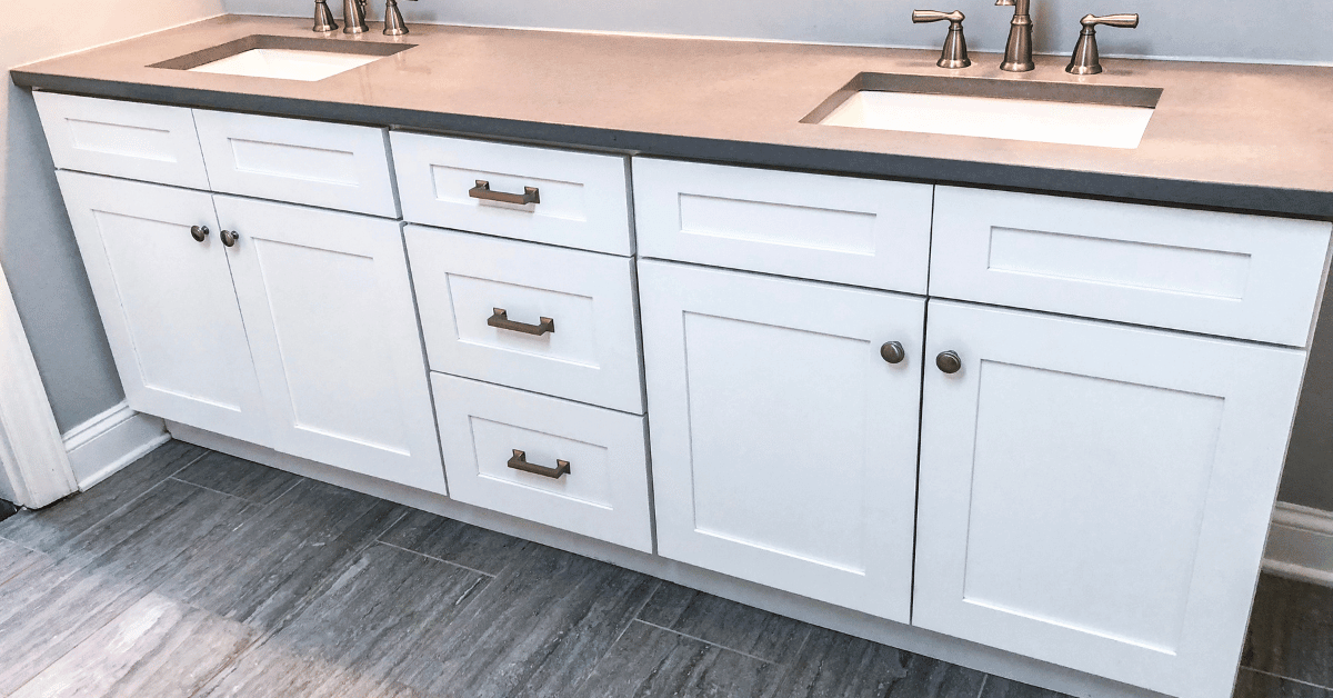 Beautiful white master bathroom cabinets with granite countertop and modern tile floor