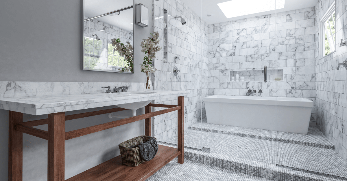 Modern bathroom with glass wet room cubicle containing a tub and shower with a marble vanity and tiles.